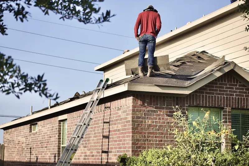 Professional roofer working on a residential roof in North Stonington